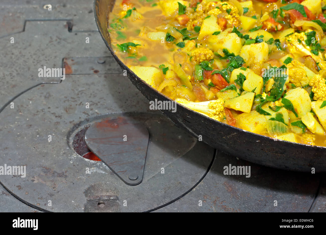 Ein Gemüsegericht auf gusseisernen Holzofen kochen Stockfoto