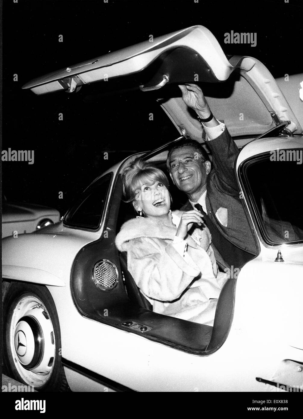Schauspielerin Catherine Deneuve in einem Sportwagen mit Mann Stockfoto