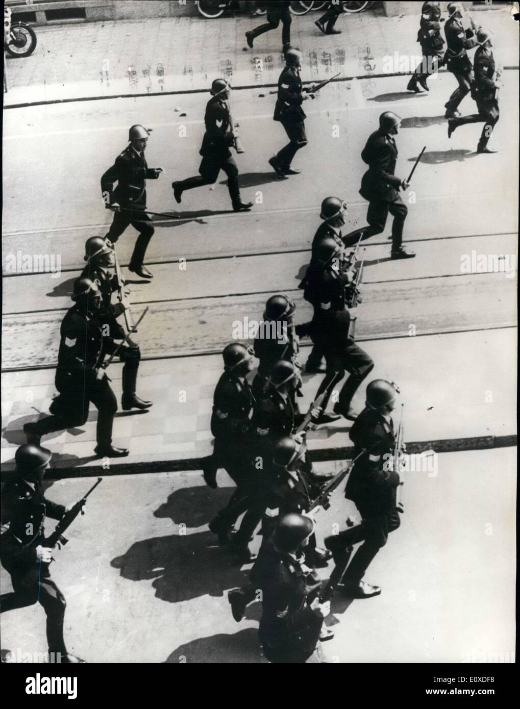 6. Juni 1966 - Polizei Feuer zeigen Bau Arbeiter In Amsterdam: Polizei feuerte auf Bauarbeiter demonstrieren in der Nähe von Königliche Palais in Amsterdam heute. Sechs Menschen wurden verletzt. Die Arbeiter, verärgert durch den Tod von einem Gipser letzte Nacht nach Polizei kollidierte mit den Arbeitnehmern, die über ein Out im Urlaub Sommerbonus protestieren. Früher randalierten sie durch die Stadt, einen LKW brennen und smashing Windows eine Zeitungsredaktion. Foto zeigt Stahl behelmte Polizei bewaffnet mit Gewehren auf die Demonstranten in Amsterdam heute. Stockfoto