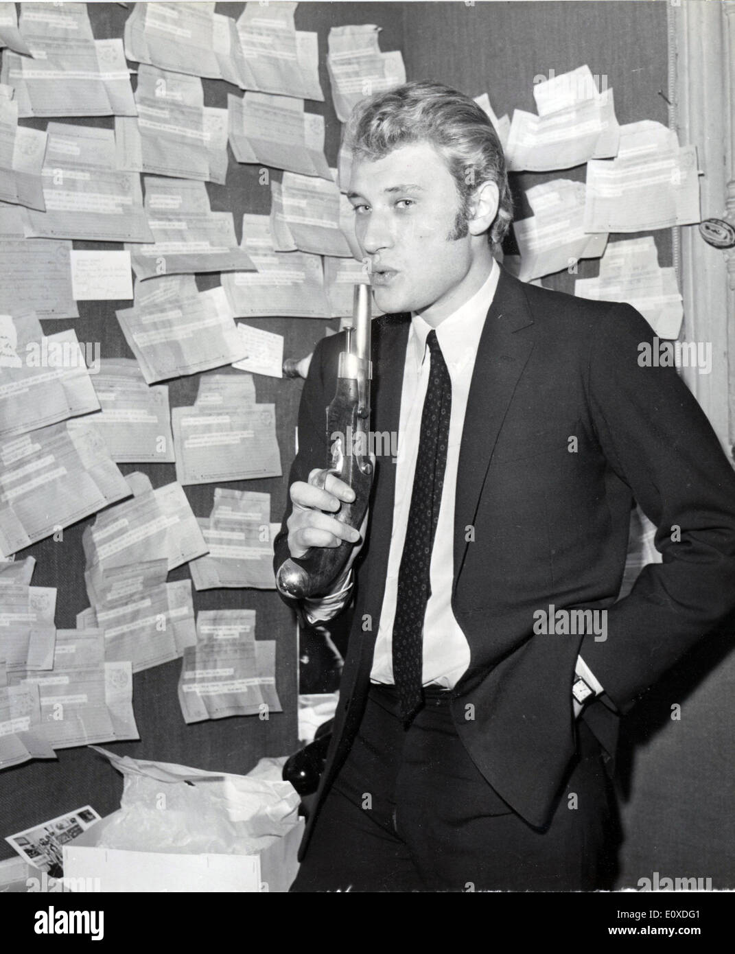 9. Juni 1966 - Paris, Frankreich - JOHNNY HALLYDAY in seiner Garderobe mit einer Pistole, die ihm von seiner Frau Sylvie Vartan, sein Lampenfieber zu töten gegeben. Genaues Datum unbekannt. Stockfoto
