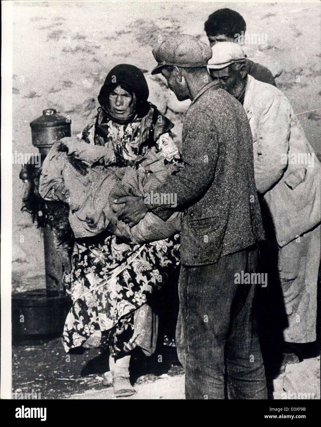 25. August 1966 - Erdbeben-Szenen aus der Türkei. Original Bilder gerade erhalten, zeigen Szenen aus Varto, die nahm die volle Kraft des Erdbebens schlug die Provinzen im Osten der Türkei am vergangenen Freitag und 2.300 Menschen getötet und 70.000 obdachlos. Foto zeigt die Trauer - betroffenen Mutter erhält der Körper ihres Kindes und in ihren Armen trägt sie geht langsam durch das Dorf. Sie hat ein paar Minuten zu ihrer Verfügung zu ihrem totes Kind waschen und wickeln Sie es in einige decken, bevor sie begraben werden soll. Stockfoto