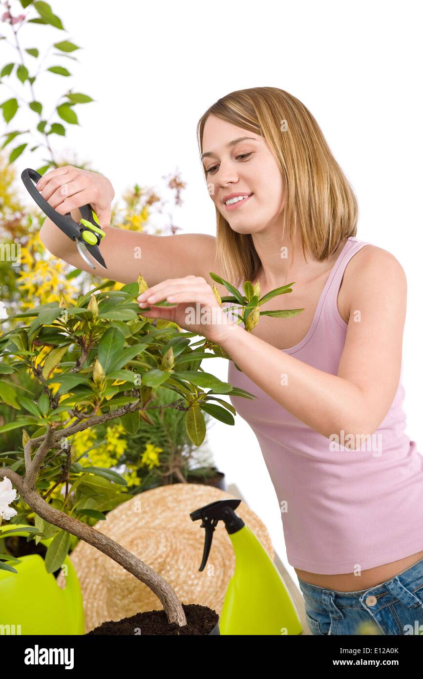 30. April 2010 - 30. April 2010 - Gartenarbeit - Happy Frauenbeschneidung Rhododendron Blüte mit Baum-, Rebscheren auf weißem Hintergrund Stockfoto