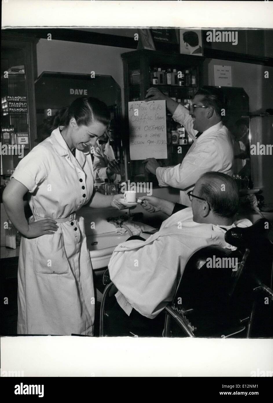 24. Februar 2012 - ein Kaffee-SERVICE in der N = BARBER SHOP. Eine Dame-Assistent dient Kunden kommen für ihr Morgen rasiert bei einem Soho Friseur Kaffee. Es ist im Preis inbegriffen. Stockfoto