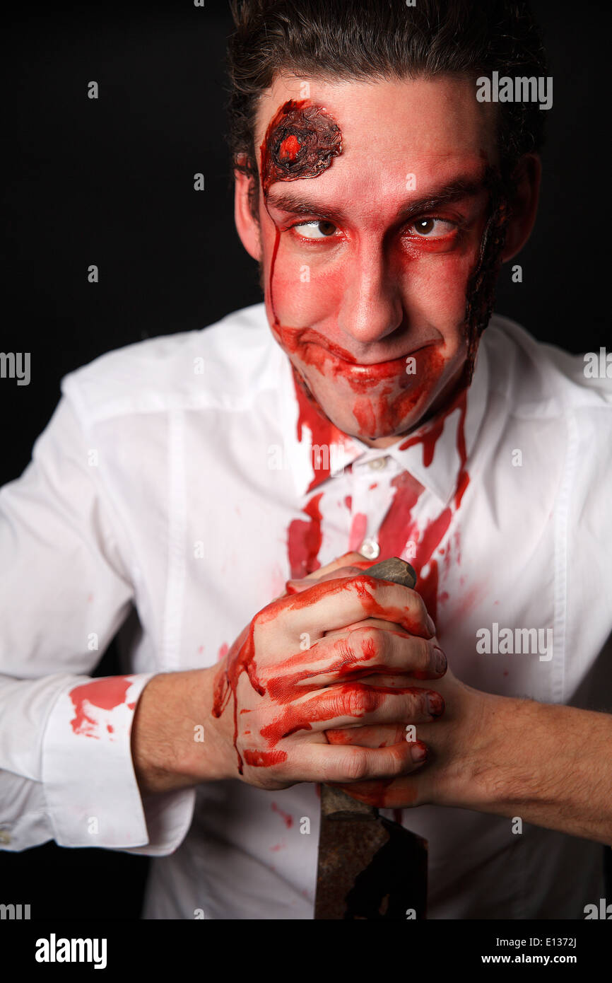 Albern aussehende Psychopath mit blutigen Messer Stockfoto