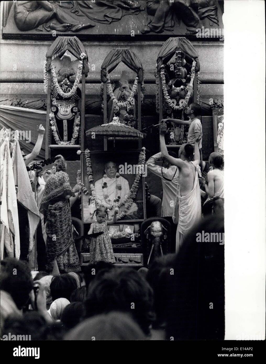 17. April 2012 - The Jagganatha Gottheiten - Lord Jagganatha (Mitte), sein Bruder Balarama und seiner Schwester Subhadra, Turm über ein Porträt seiner göttlichen Gnade a. c. Bhaktivedents Swami Prabhupada, umgeben von Anhängern auf eine Krishna-Bewusstsein Bewegung Festival im Londoner Trafalgar Square. Stockfoto