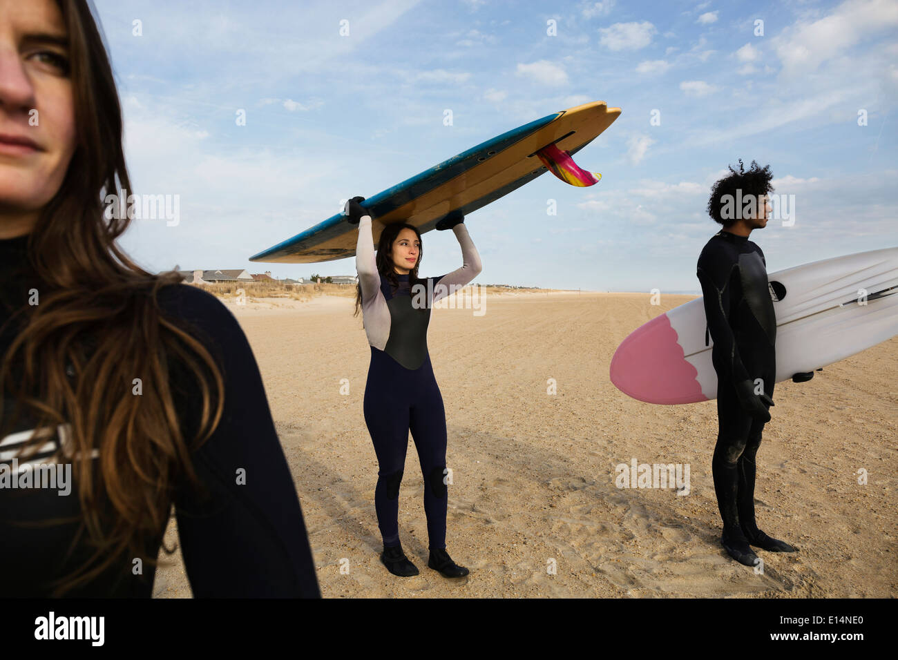 Surfer, die Bretter am Strand tragen Stockfoto