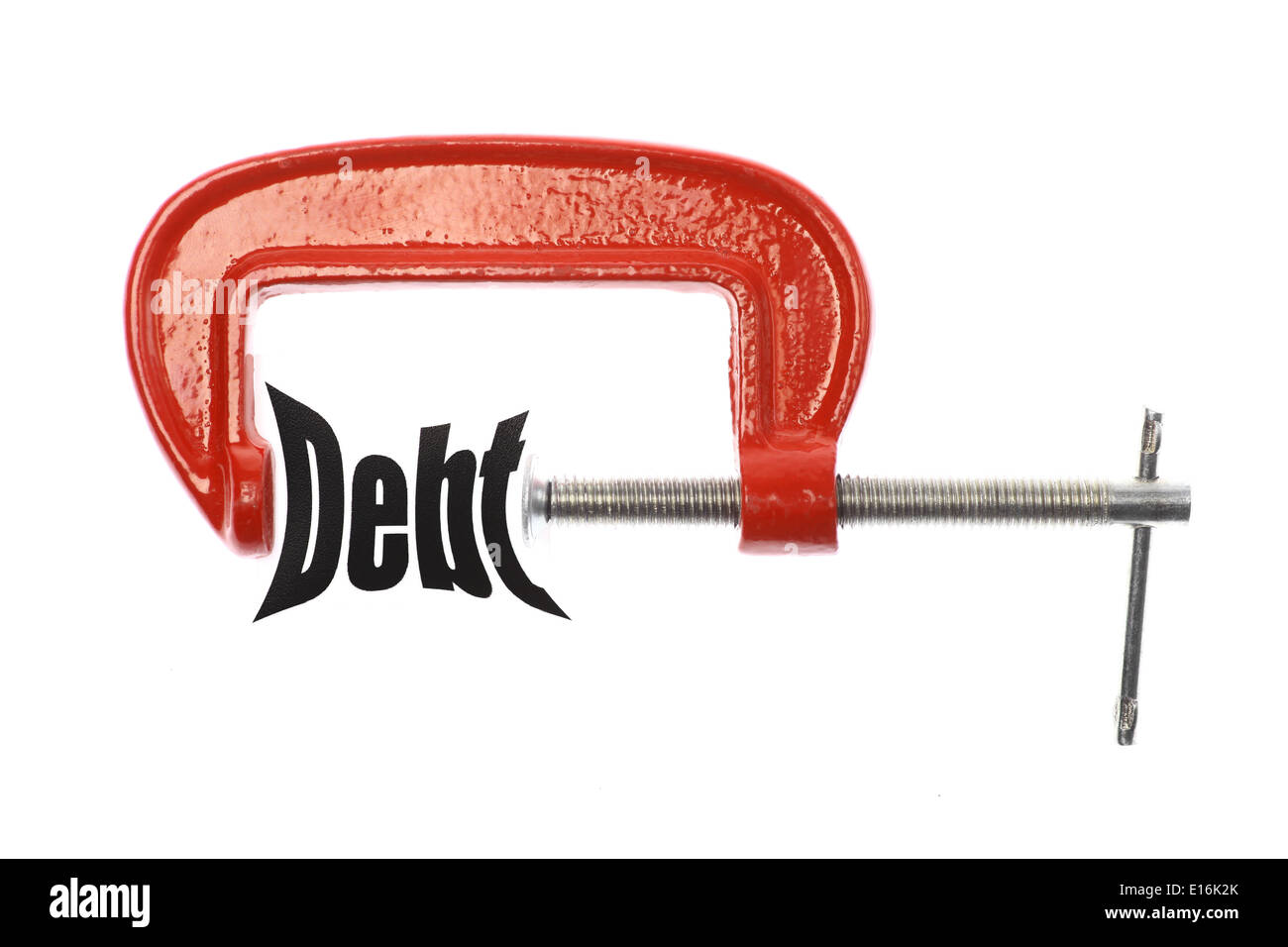 Das Wort "Schulden" ist mit einem Schraubstock komprimiert. Business-Metapher. Stockfoto