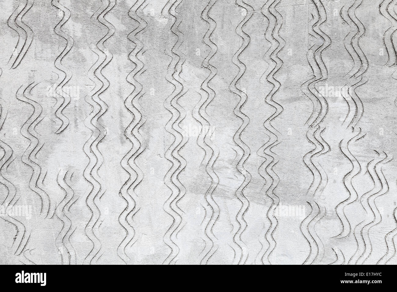 Graue Betonwand Textur mit gewellten Ausklinkmaschinen Muster Stockfoto