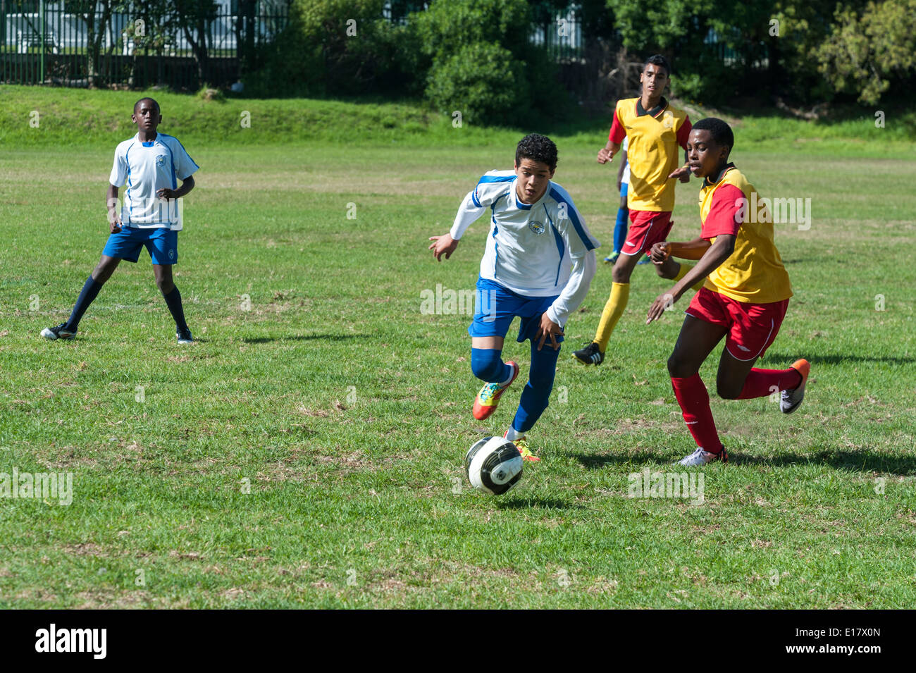 Junior Football-Spieler gegen den Ball, Cape Town, Südafrika Stockfoto