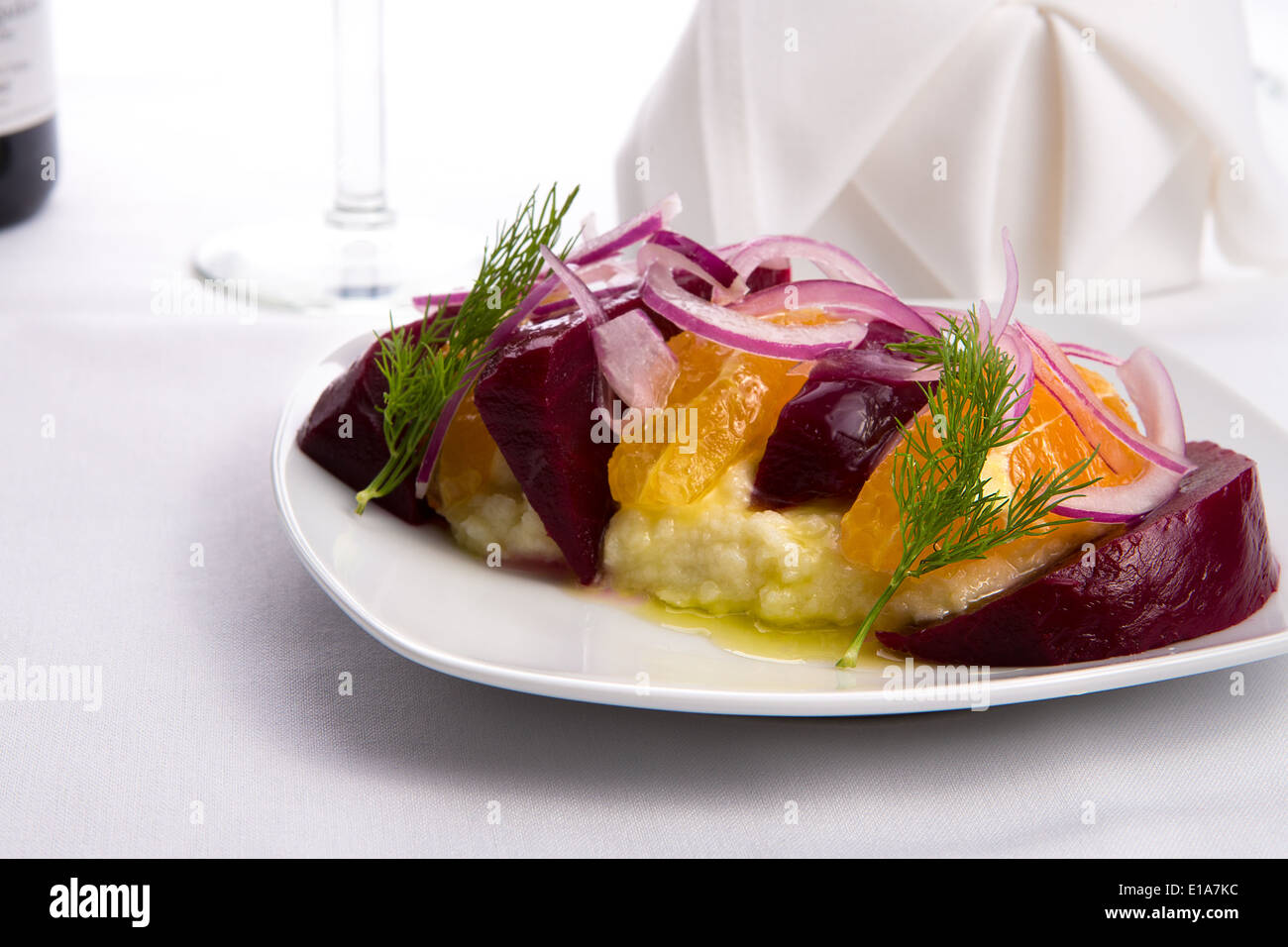 Gespannte Joghurt Labneh Zitrus-Salat mit eingelegten Rüben und geschälte Orangen garniert mit Zwiebeln und Dill serviert mit Öl Stockfoto