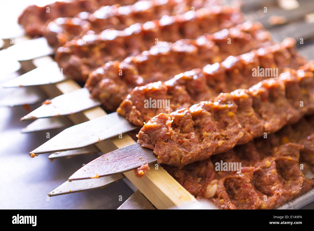 Mehreren Adana Kebab Spieße aufgereiht warten darauf, zubereitet und serviert Stockfoto