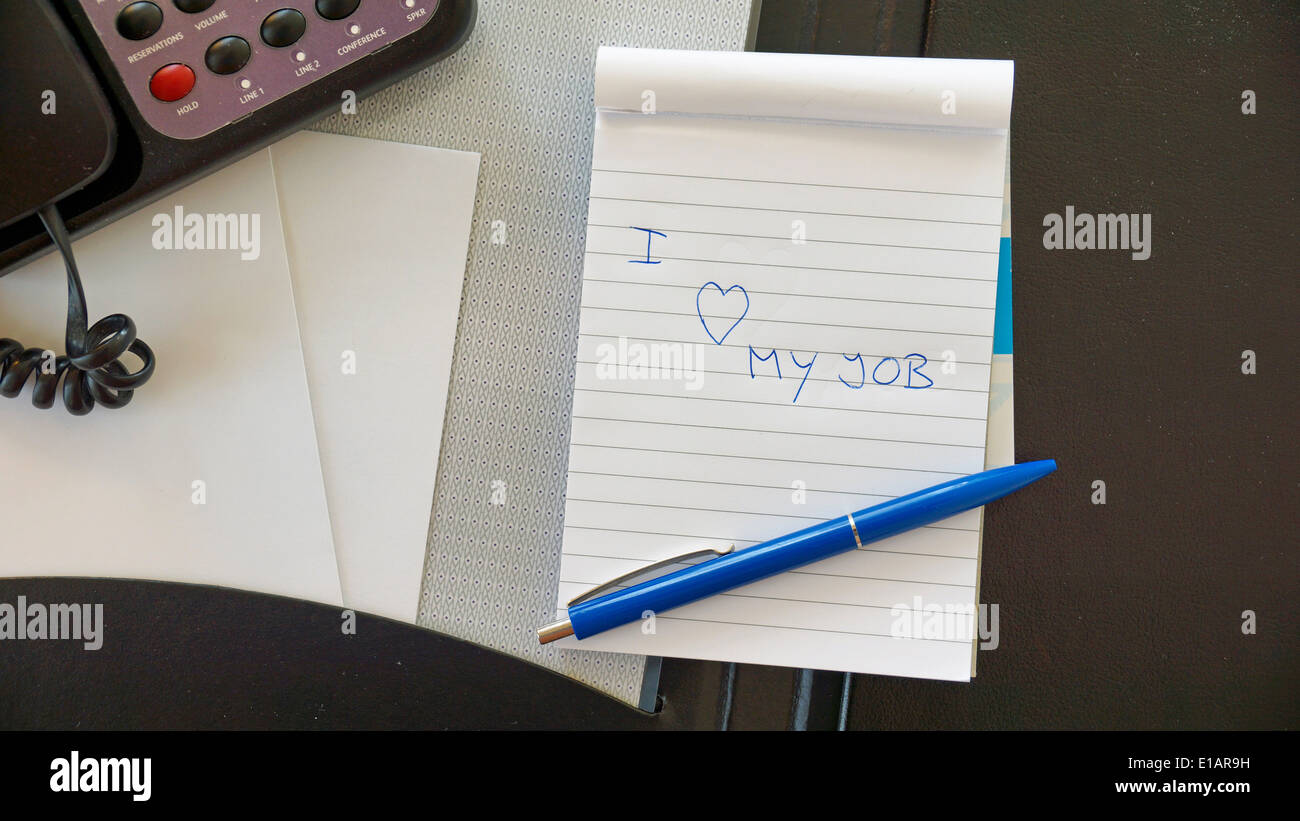 Ich liebe meinen Job, geschrieben am Blocknote im Büro Stockfoto
