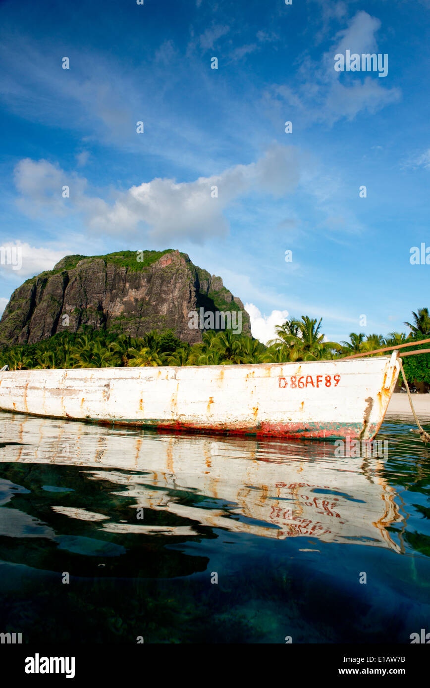 Einem alten hölzernen Fischerboot schwimmende neben Reflexionen von Le Morne Brabant Berg, Mauritius, The Indian Ocean Stockfoto