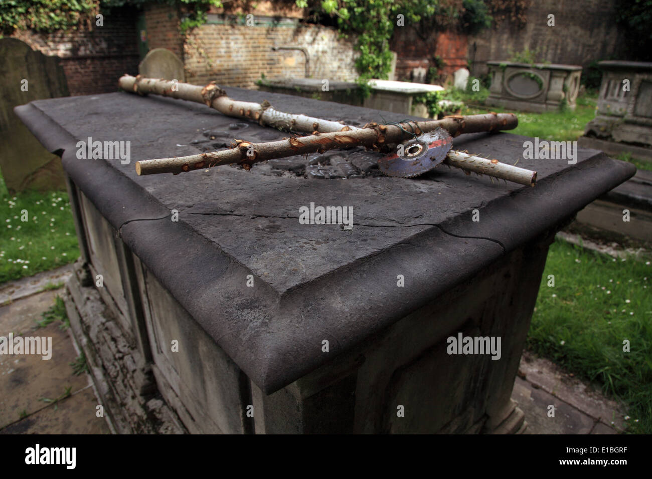 Provisorische Kreuz mit einer Scheibe Klinge ruht auf einem Grabstein Stockfoto
