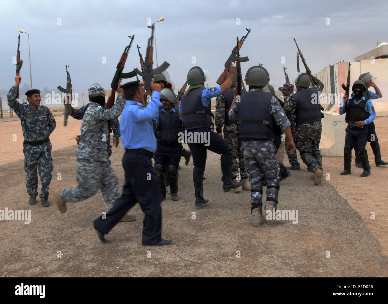 Irakische Polizisten Studenten feiern, vorbei an einem Gebäude löschen Test an einer Polizeiakademie in Basra, Irak, 20. April 2011. (DoD Foto Stockfoto