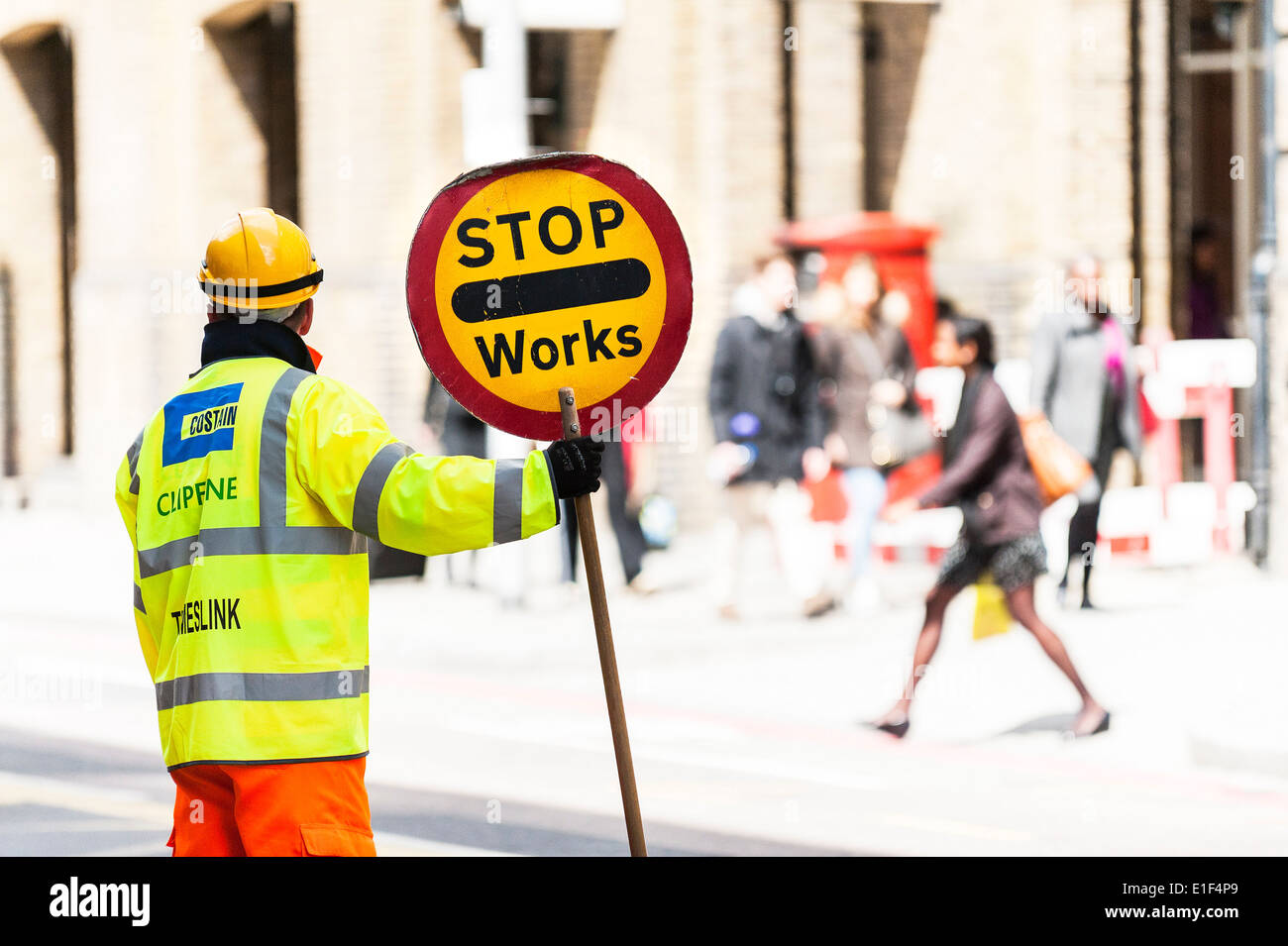 Ein Bauarbeiter mit einem Verkehr-Stop-Schild. Stockfoto