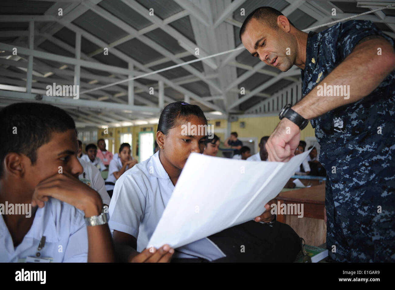 U.S. Navy Lt. Mike Kavanaugh, Recht, spricht mit Studenten über Mücken, die Infektionskrankheiten während einer Gemeinschaft Serv tragen Stockfoto