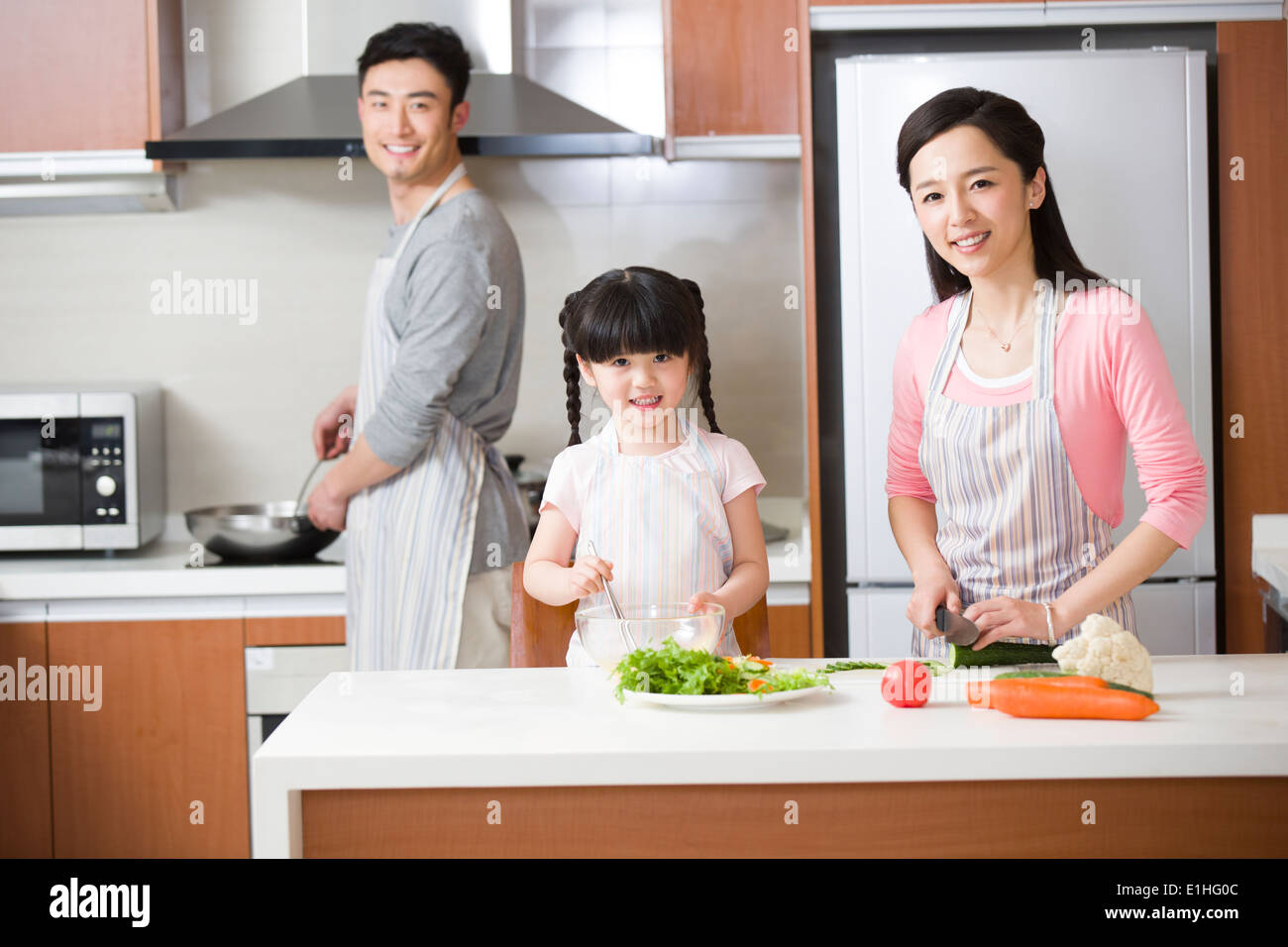 Glückliche junge Familie in Küche Stockfoto