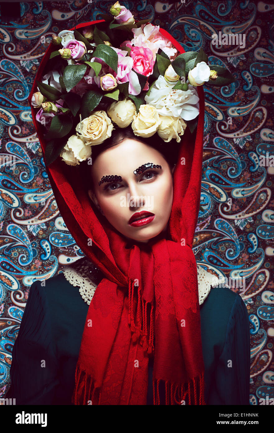 Jahrgang. Frau im roten Schal und Kranz aus Rosen. Retro Stockfoto