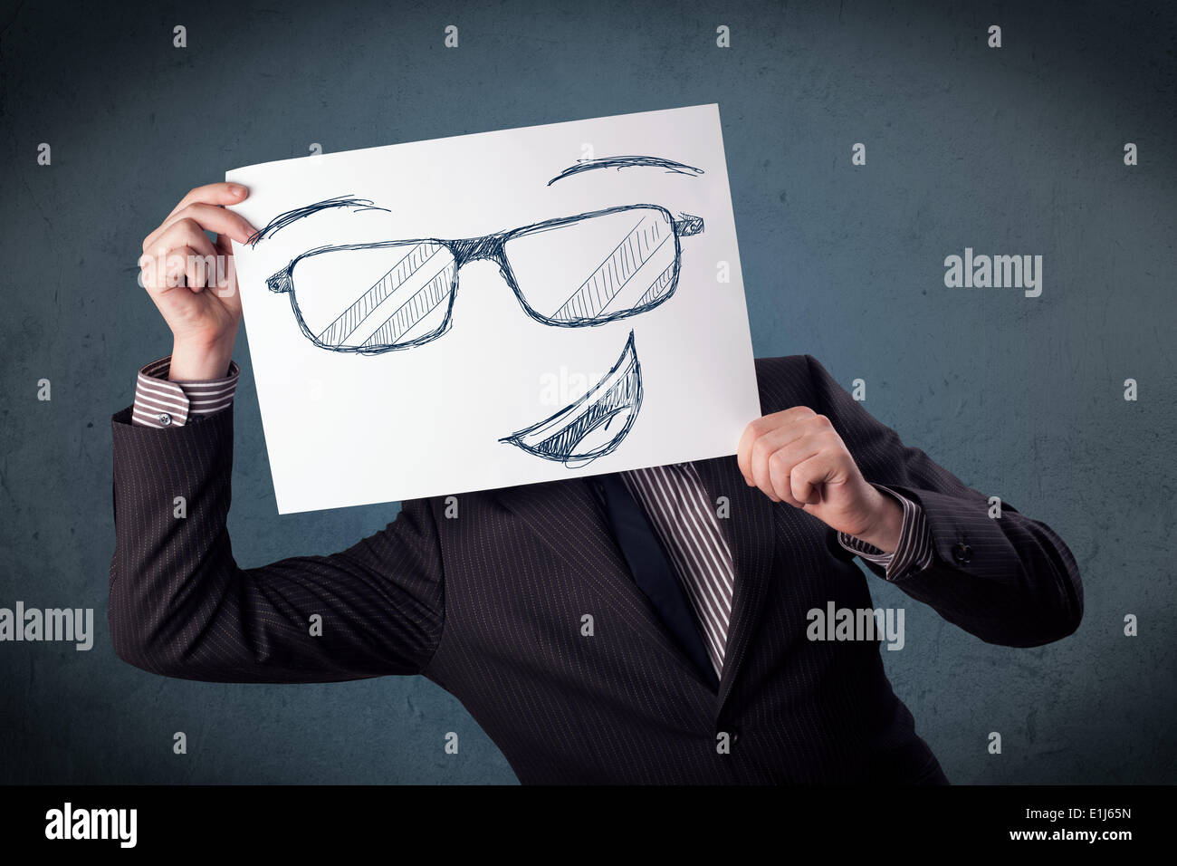 Geschäftsmann, eine Papier mit Smiley-Gesicht vor den Kopf halten Stockfoto