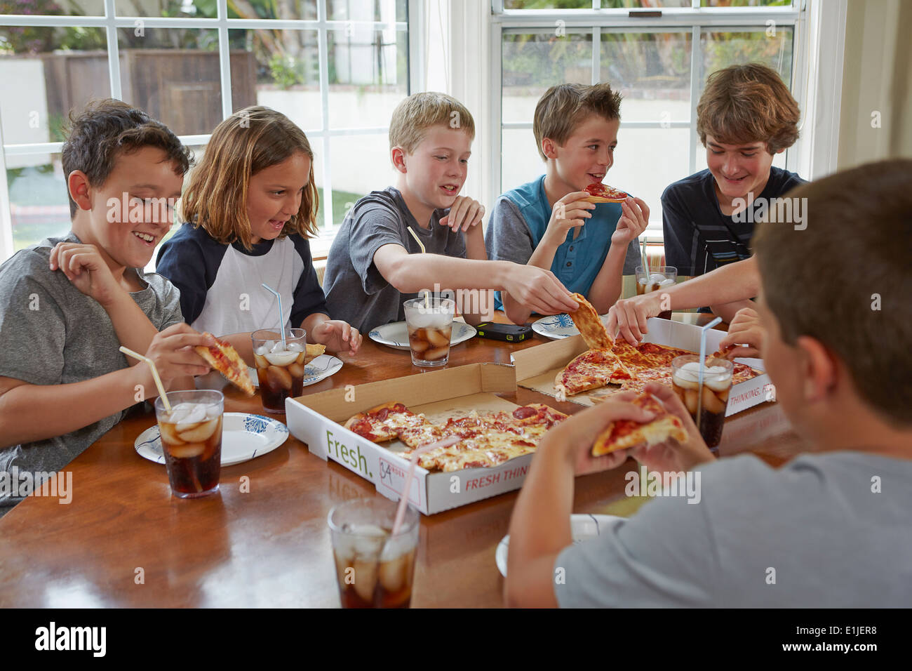 Gruppe von jungen teilen pizza Stockfoto