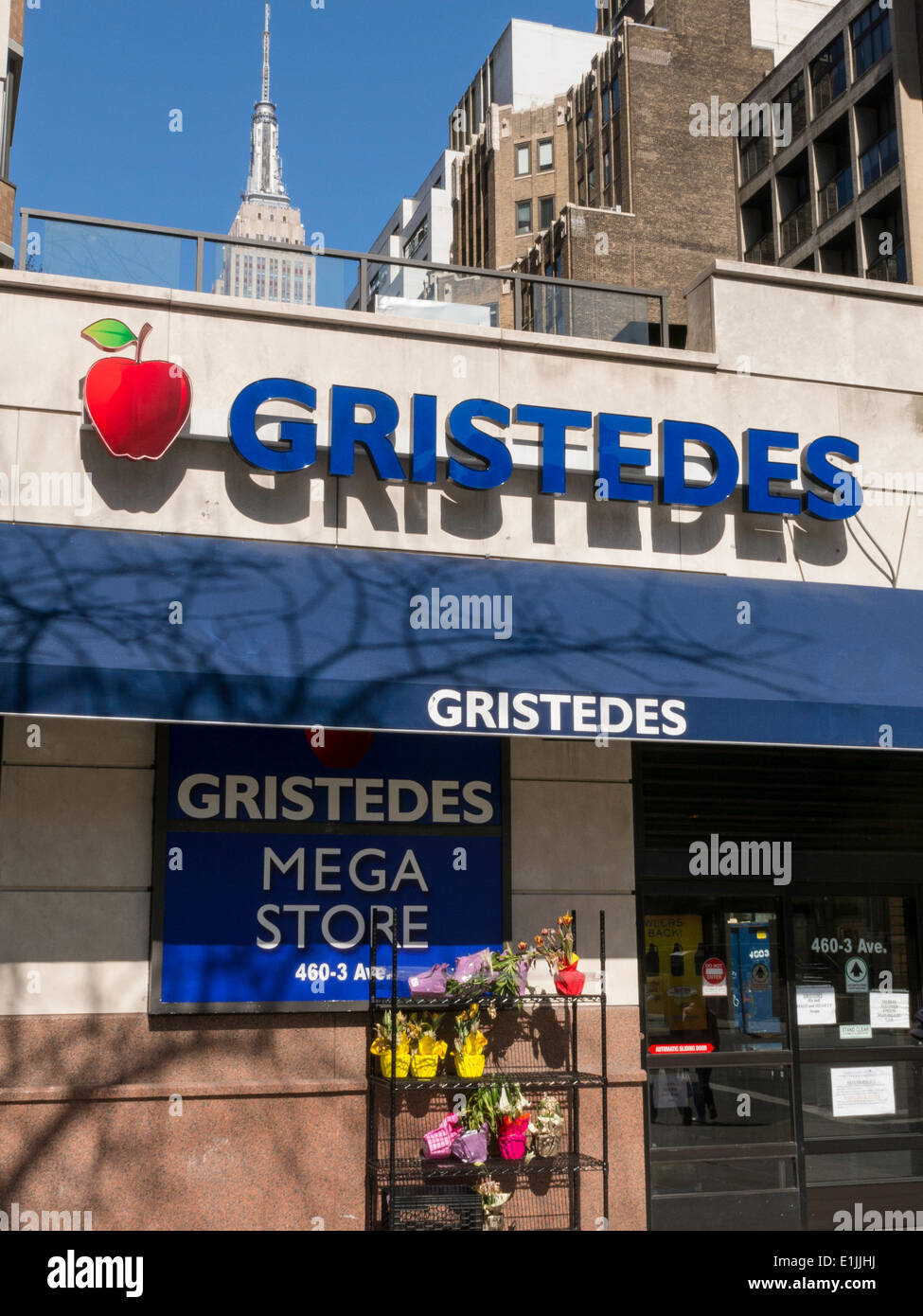 Gristedes Supermarkt-Eingang mit Empire State Building im Hintergrund, NYC, USA Stockfoto