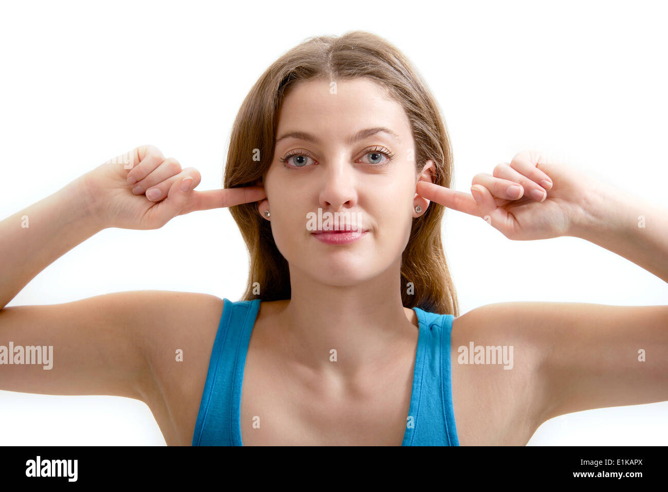 MODEL Release Teenage Mädchen mit ihren Fingern in den Ohren. Stockfoto
