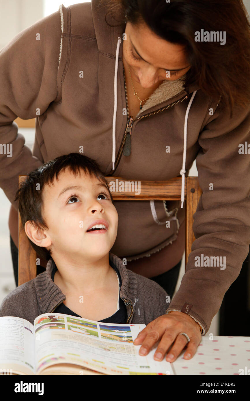 Mutter ein 6 Jahre alten Jungen mit seinen Hausaufgaben zu helfen Stockfoto