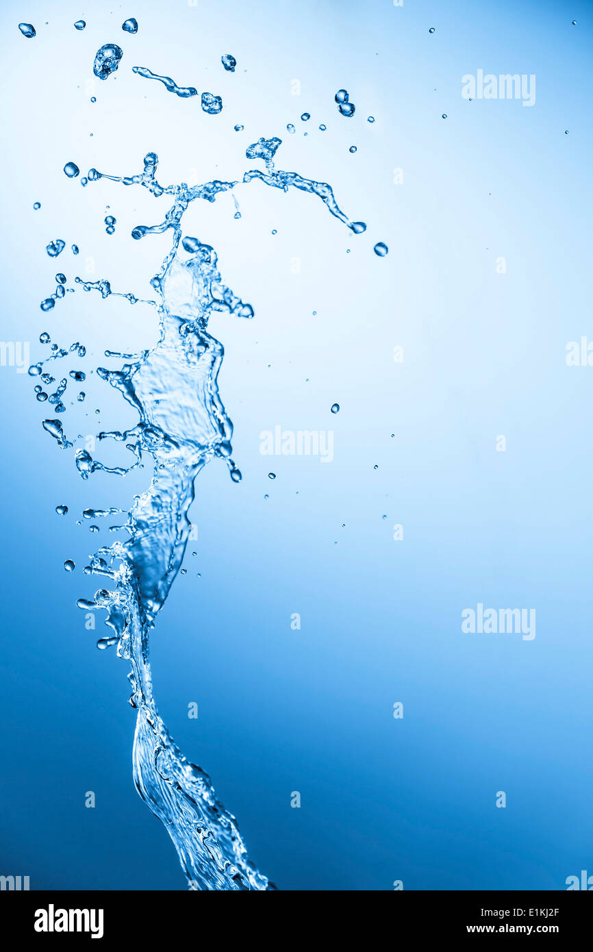 Wasser fällt auf blauem Grund. Stockfoto