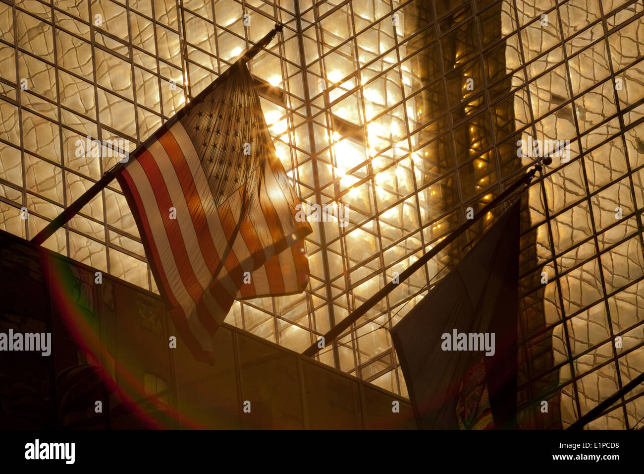 US-Flagge im Bild gegen eine helle Sonne Spiegelung im Glasbau, Manhattan New York Stockfoto