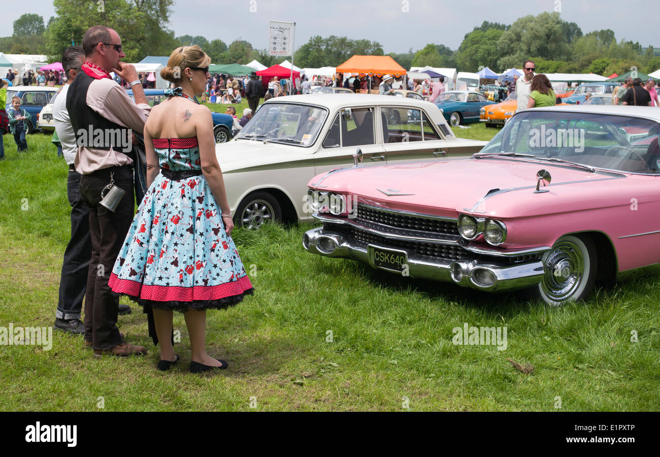 Menschen verkleidet in eine nostalgische und Vintage Show pink Cadillac betrachten. England Stockfoto