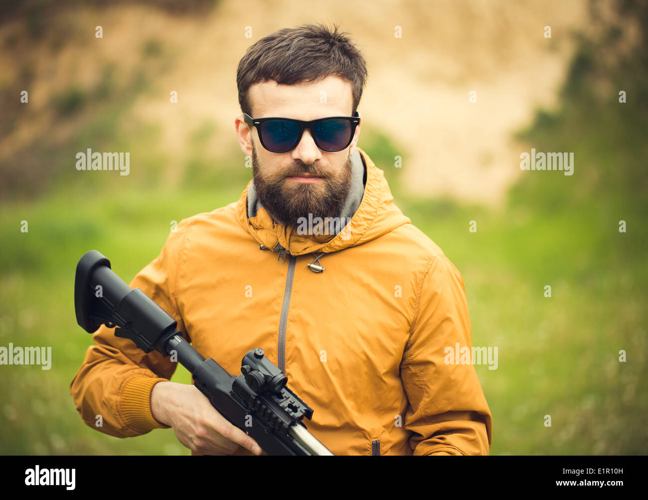 Ein Mann mit einem automatischen Gewehr im freien Stockfoto