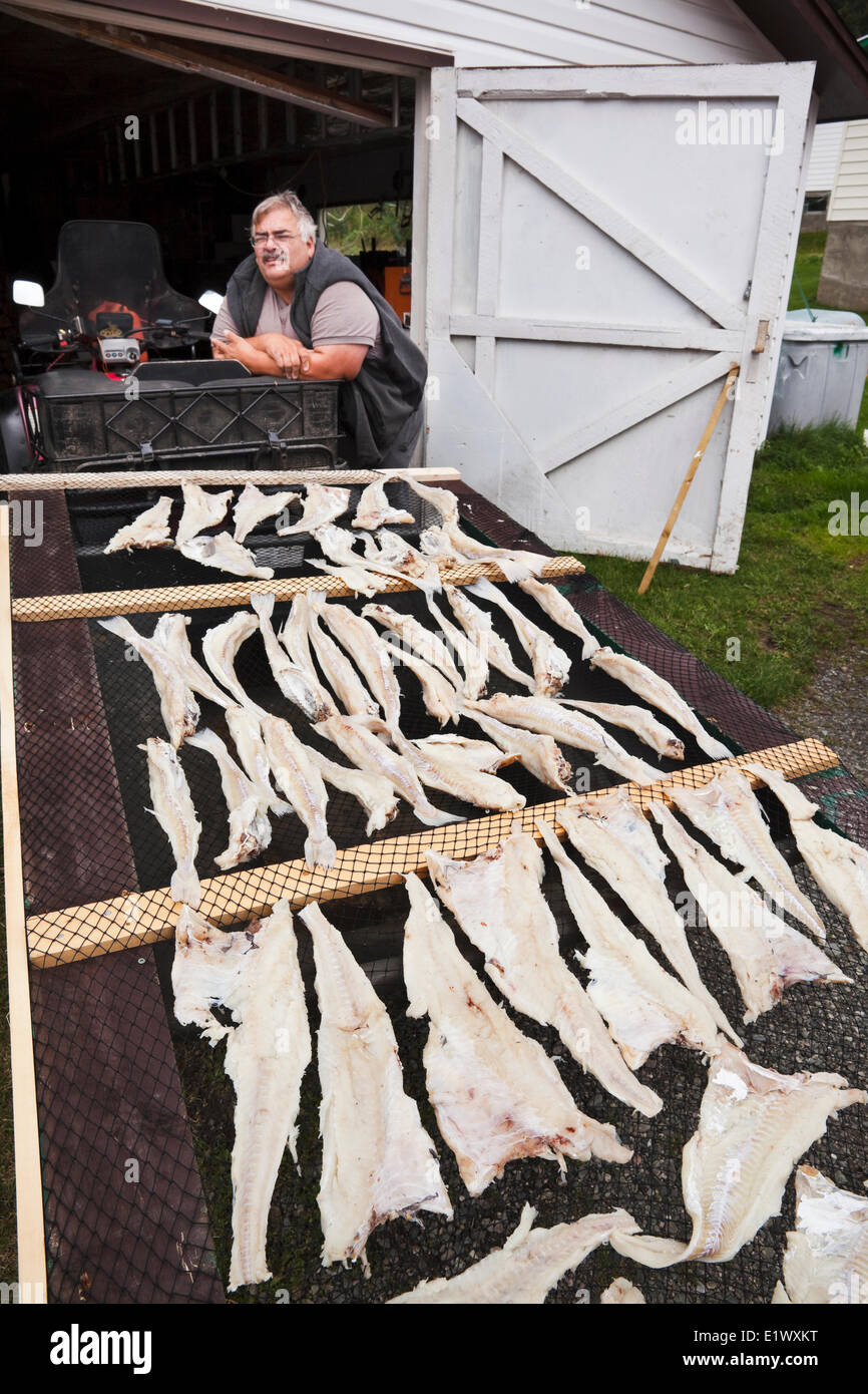 Mann stehend neben Fische trocknen Rack, Neufundland, Kanada Stockfoto