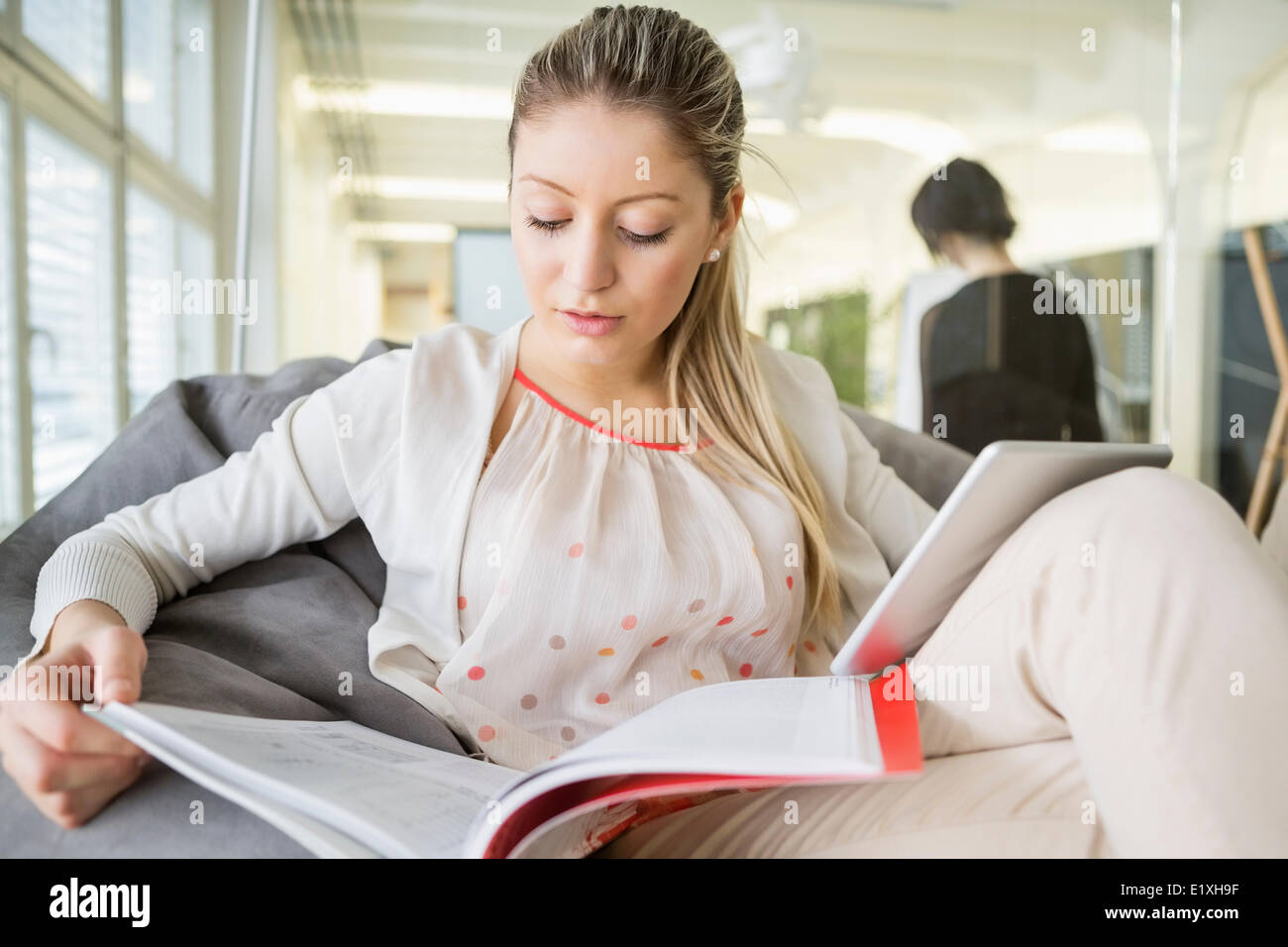 Junge Geschäftsfrau mit digital-Tablette Lesebuch im Büro Stockfoto
