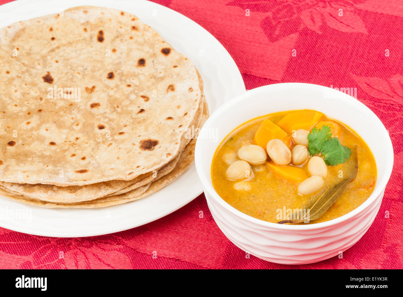 Mit Leckeres indisches Gemüse-Curry serviert hausgemachte Chapati (indisches Brot). Es wird mit Karotten, Bohnen und Gewürzen zubereitet. Stockfoto