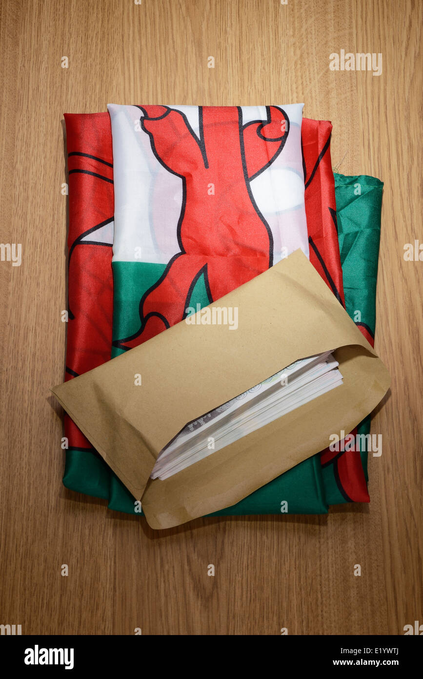 Walisische Flagge mit einem braunen Umschlag voller Geld Stockfoto