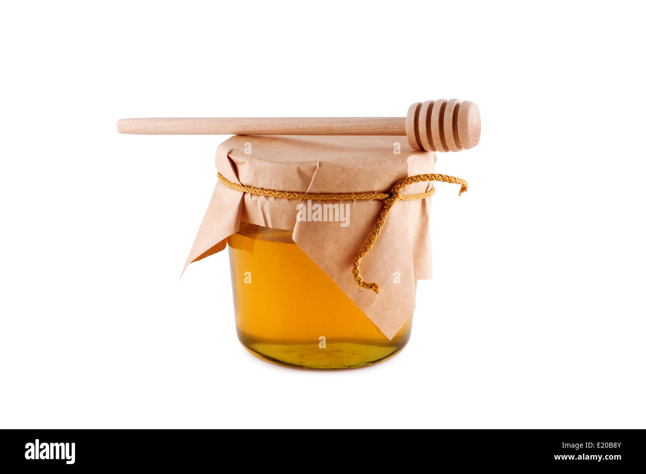 Honig im Glas Holzlöffel isoliert weiß. Stockfoto