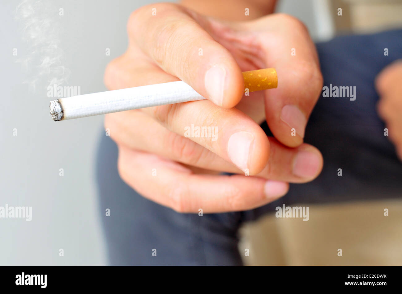 ein junger Mann eine Zigarette rauchend Stockfoto