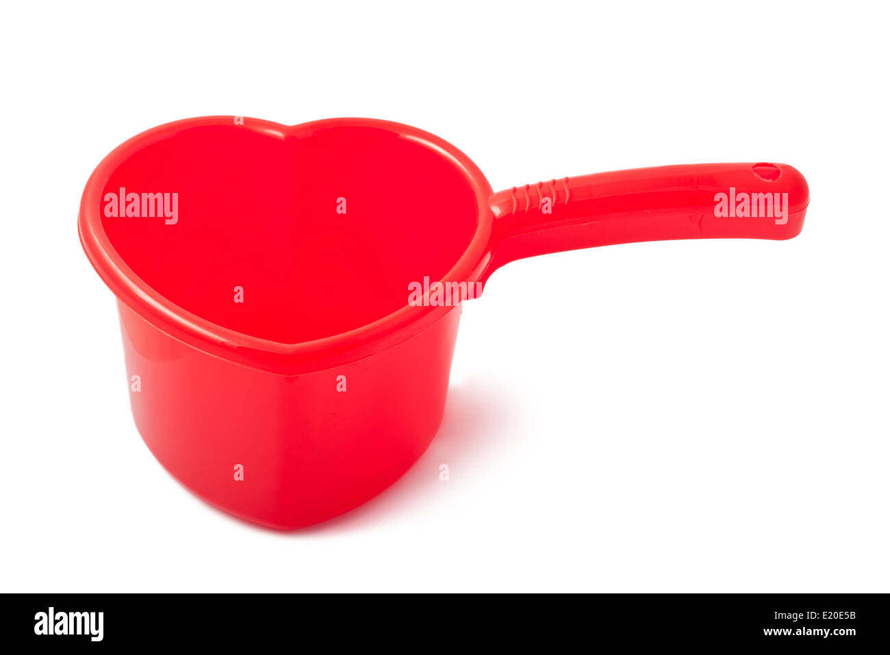 Roter Kunststoff Kelle ähnlich wie ein Herz Stockfoto