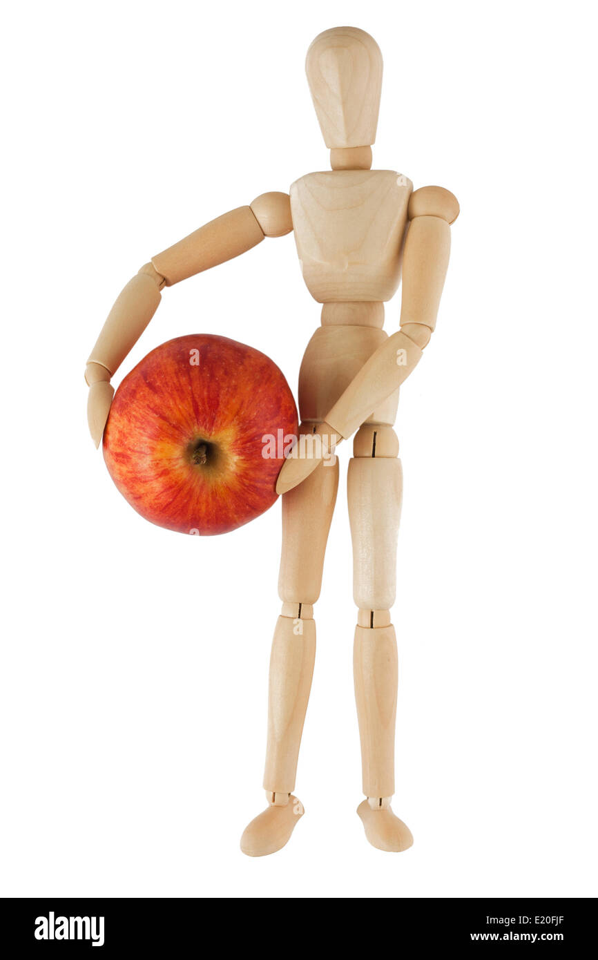 Hölzerne Puppe hält roten Apfel Stockfoto