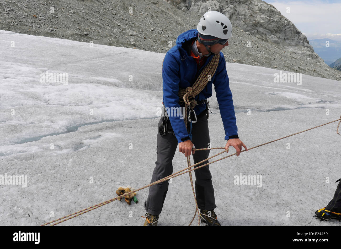 Bergführer zeigt, so dass ein Prusik-Knoten und ein Seil für Spaltenbergung auf einem alpinen Kletterkurs einrichten Stockfoto