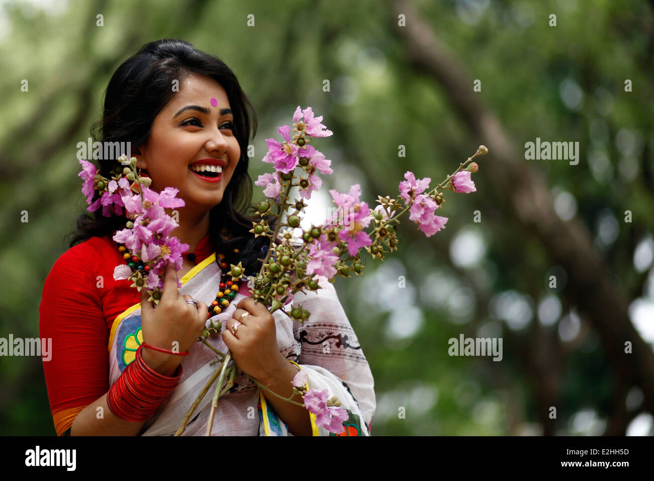 Bangladeshi Mädchen genießen mit Sommerblumen Stockfoto