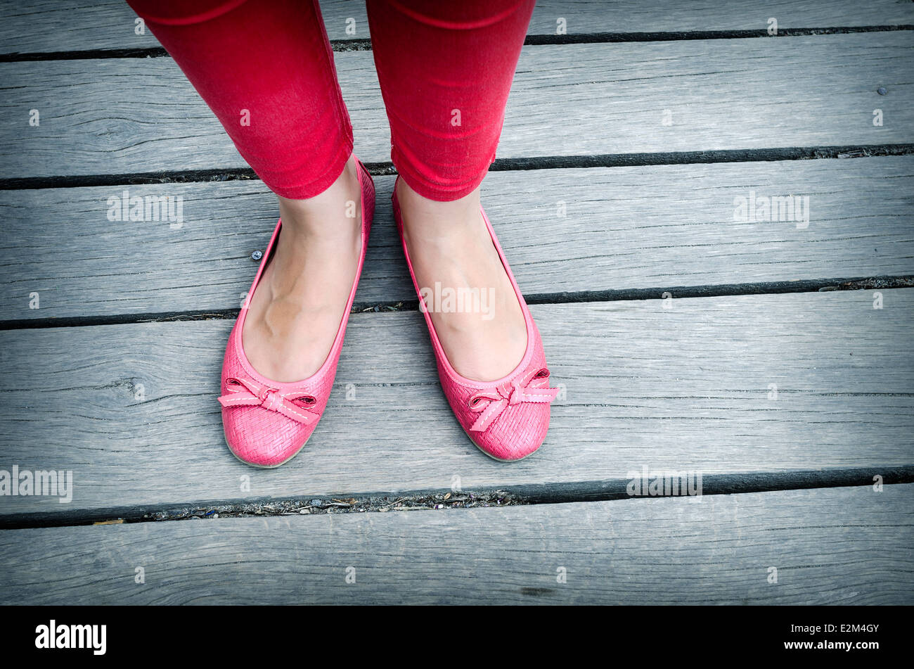 Schöne Mädchen rosa Schuhe über Holzterrasse Stockfoto
