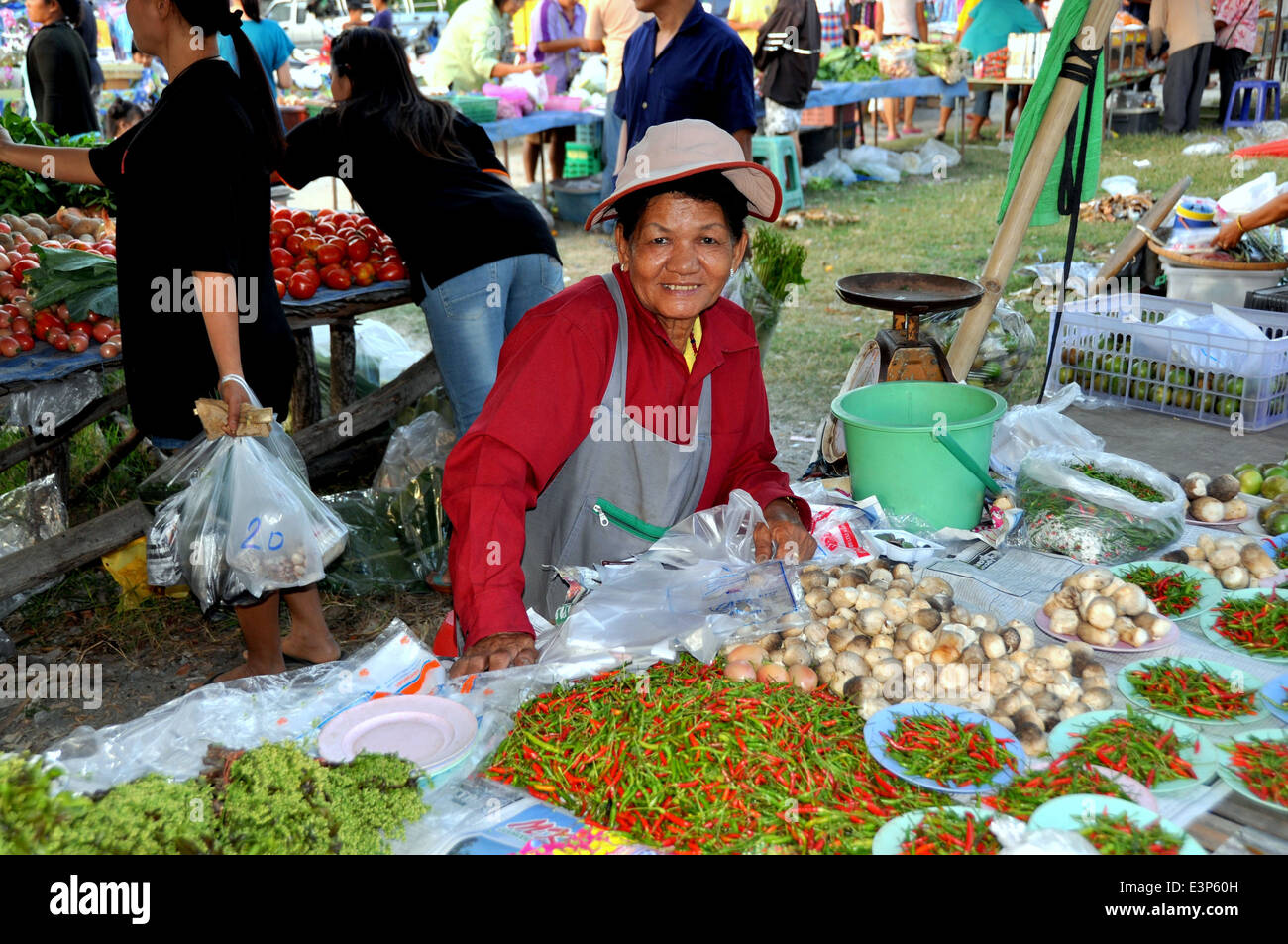 BANGKOK, THAILAND: Frau verkaufte Chilischoten und anderen Lebensmitteln an ihrem Stand in der Markthalle Chatuchak frisch Stockfoto