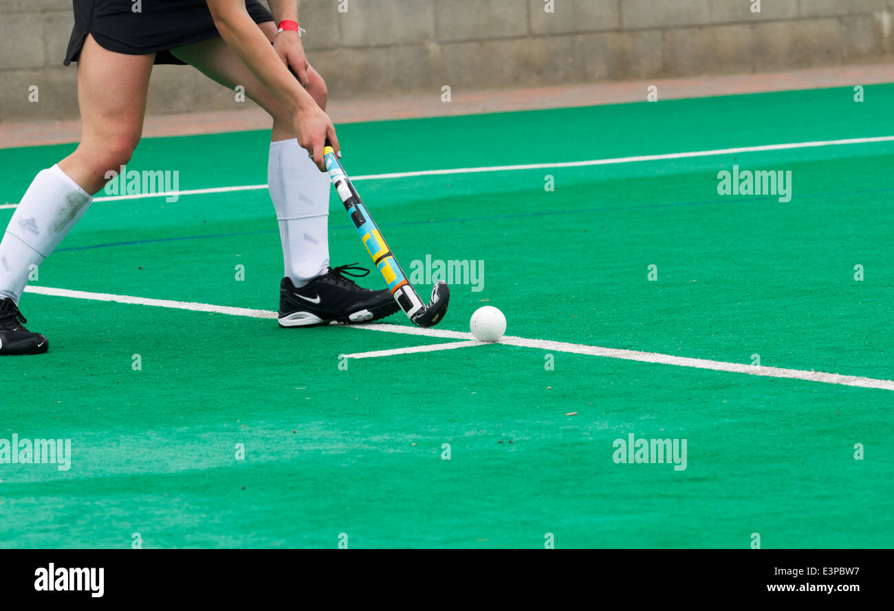 Weibliche Hockeyspieler legt den Ball im Spiel nach einem foul Stockfoto