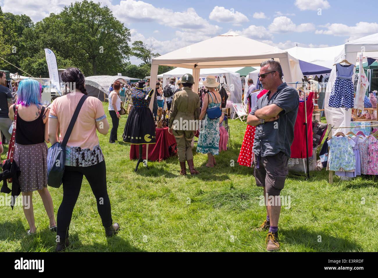 East Devon, England. Juni 2014. Eine Fete und Gartenparty mit Ständen verkauft Gegenstände und Lebensmittel. Ein Weibchen trägt GI WW2-Kit. Stockfoto