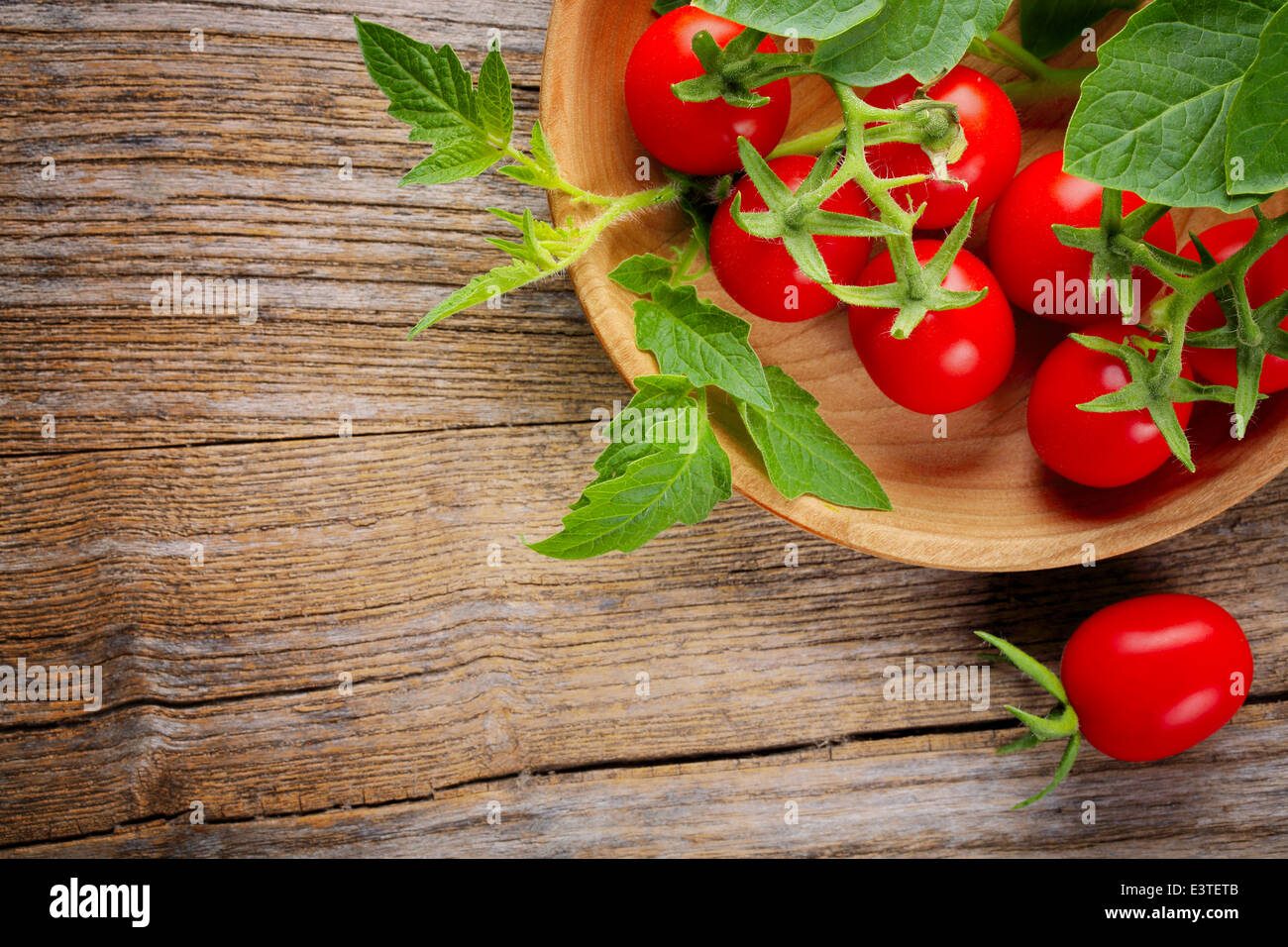 Frische Kirschtomaten auf einem Holztisch. Stockfoto