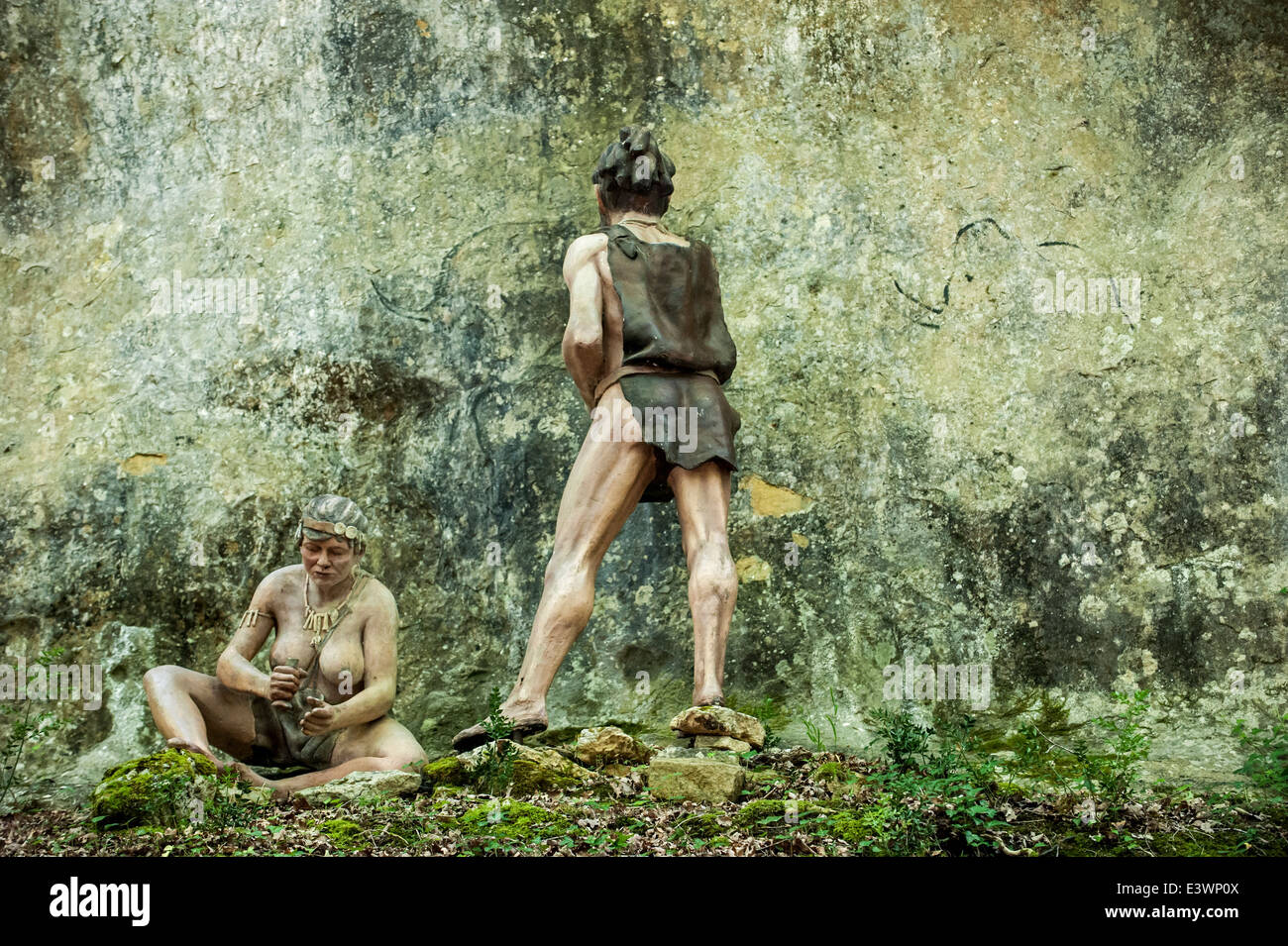 Cro-Magnon-Frau und Mann Malerei Tiere auf der Felswand im Prehisto Parc über das prähistorische Leben auf Tursac, Dordogne, Frankreich Stockfoto