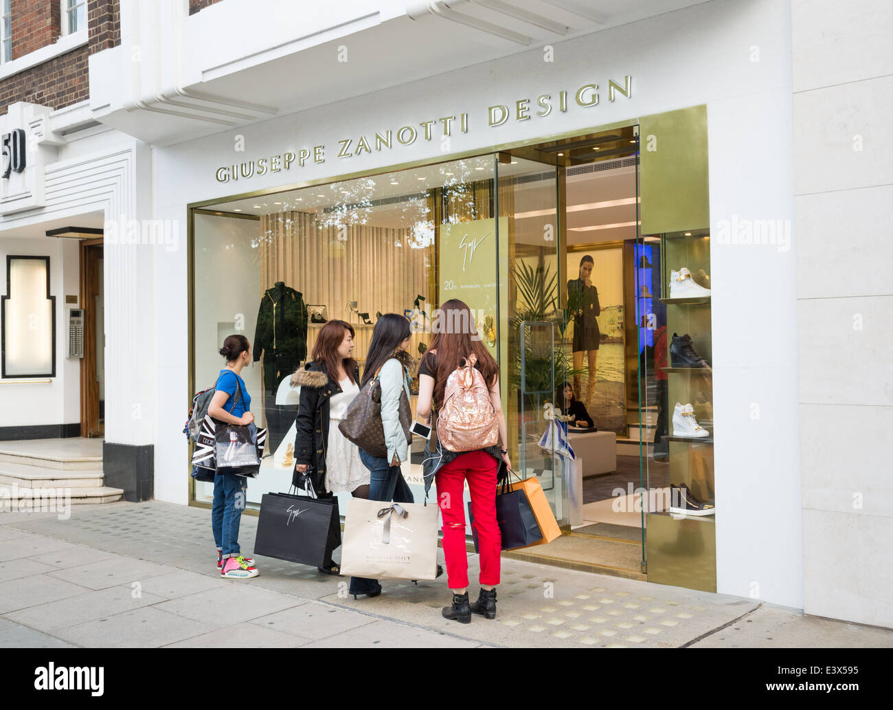 Wohlhabende asiatische Touristen Einkaufen auf Sloane Street, London, England, UK Stockfoto