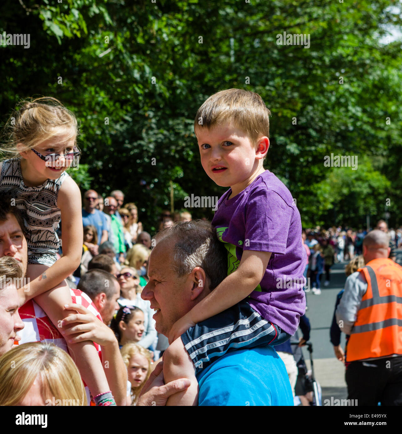 Kinder in Holmfirth auf der 2. Etappe der Tour de France 2014 eine Vogelperspektive des Verfahrens gegeben. Tausende Menschen säumten die Straßen mit einem scharfen Wettbewerb um den besten Blick auf die herannahenden Hauptfeld zu erhalten. West Yorkshire, Großbritannien Stockfoto